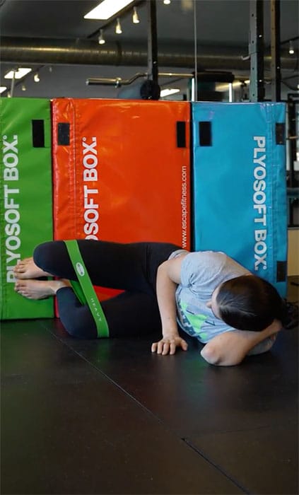 image of woman doing hip strengthening exercise with mini exercise band